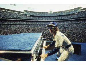 English singer songwriter Elton John performing at Dodger Stadium in Los Angeles, 1975. He is wearing a sequinned baseball outfit. (Photo by Terry O'Neill/Getty Images)